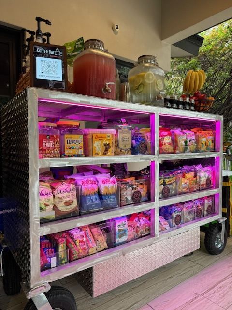 The snack cart with lit shelves of chips and treats